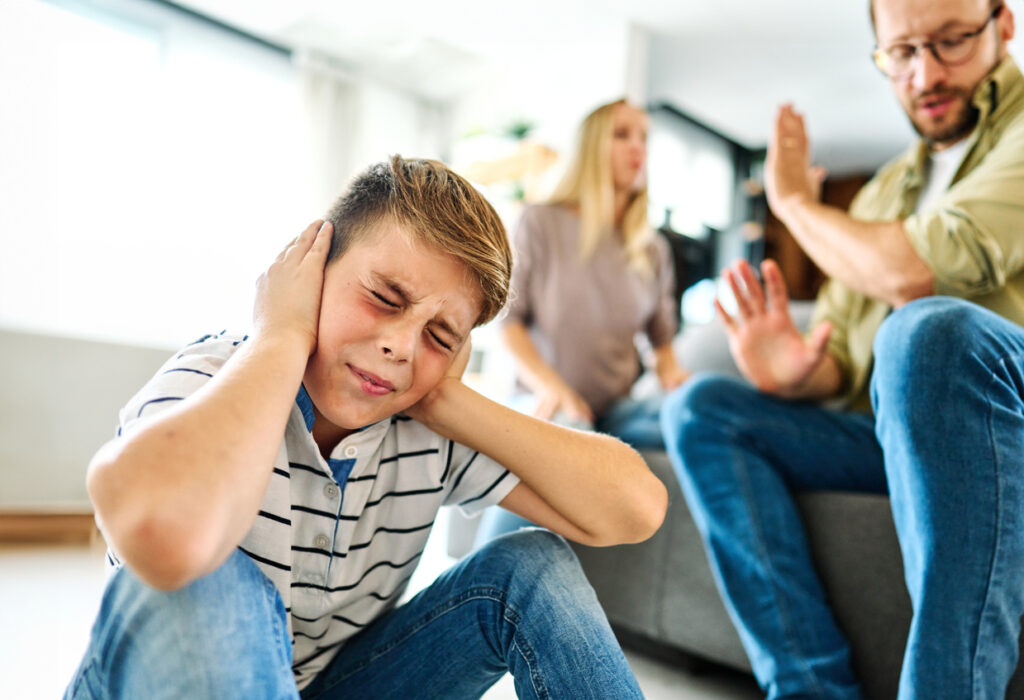 sad little boy and parents in conflict