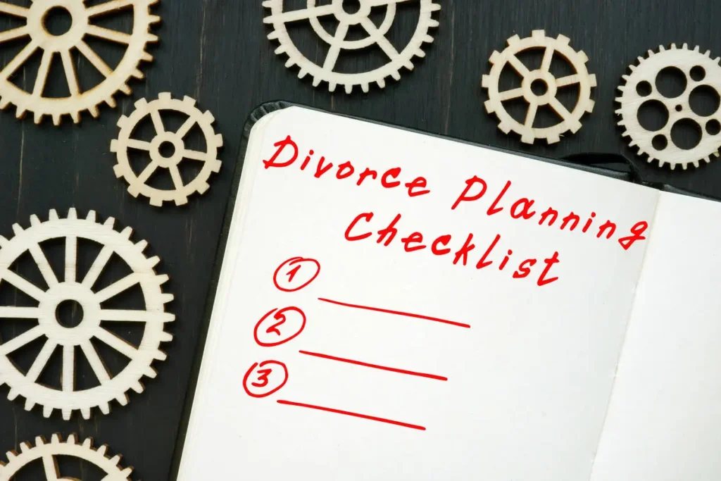 Divorce planning checklist with numbered lines and gears on a wooden background, symbolizing organization.