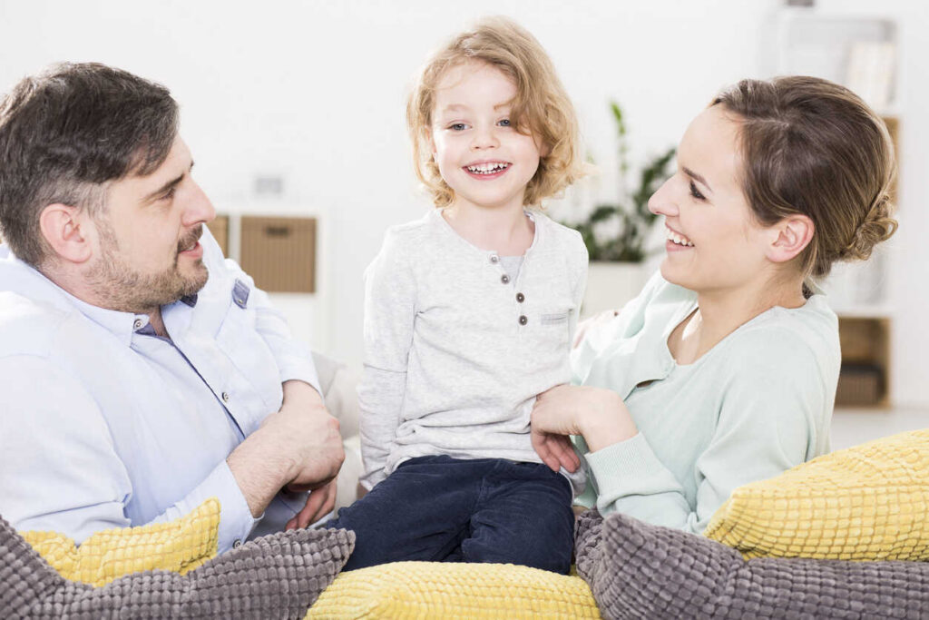 Couple siiting with their child and seeing happy for the Law order of Child Support